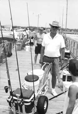 Carl Bedsole, 63, formerly of Fayetteville, has his own pier cart ready each morning to fish for specks at Long Beach.